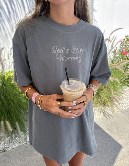 GOD'S STILL WORKING Unisex Tee