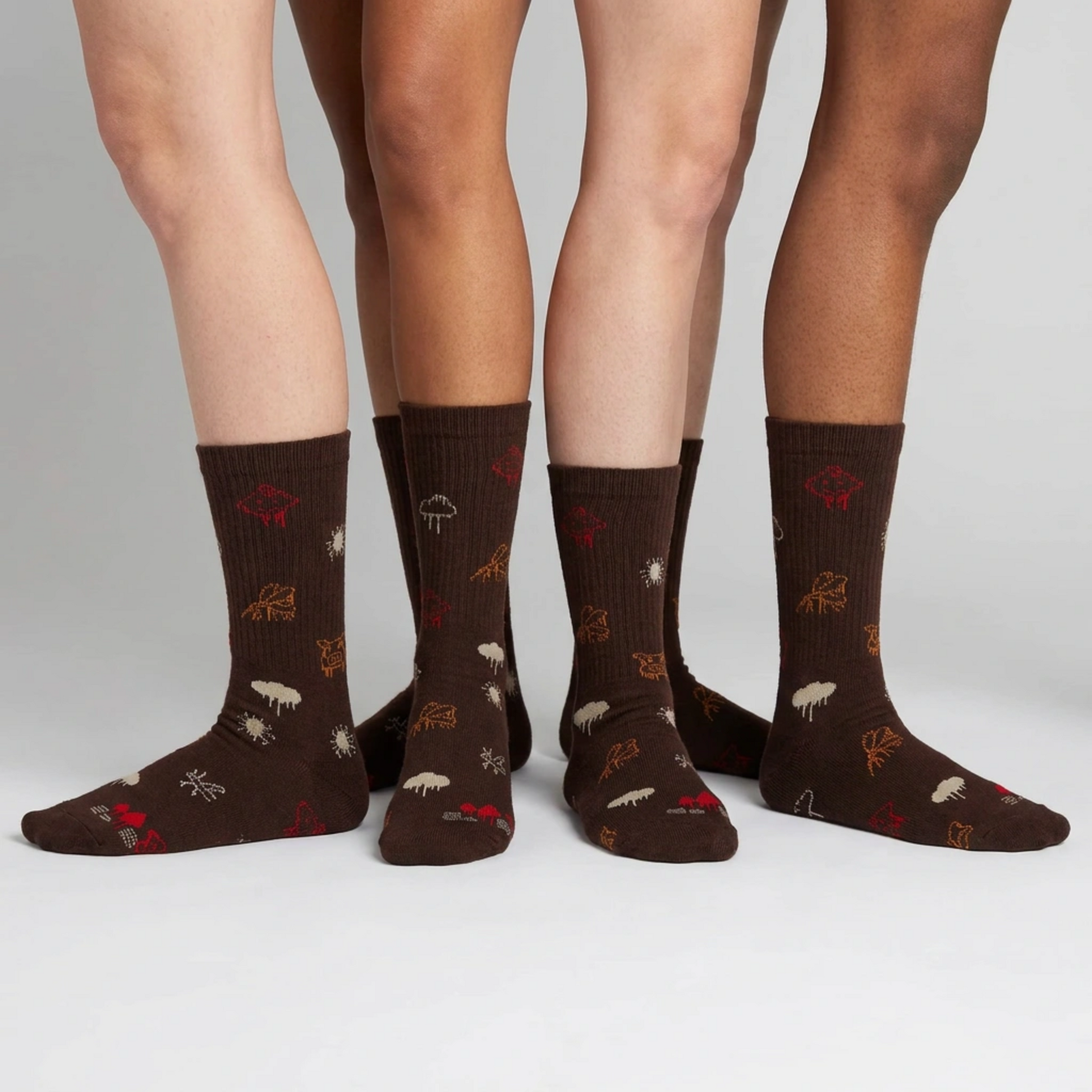 Brown socks with animal patterns worn by four people on a white background