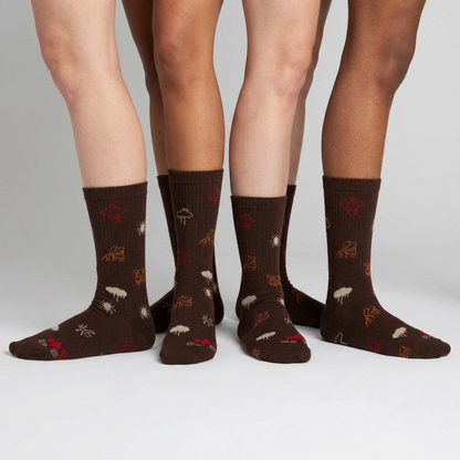 Brown socks with animal patterns worn by four people on a white background